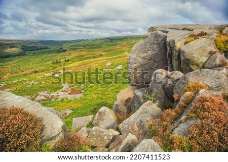 Burbage Edge is a gritstone escarpment overlooking the Burbage district of Buxton in Derbyshire, in the Peak District. The hill's summit is 500 metres above sea level.  Royalty-Free Stock Photo #2207411523