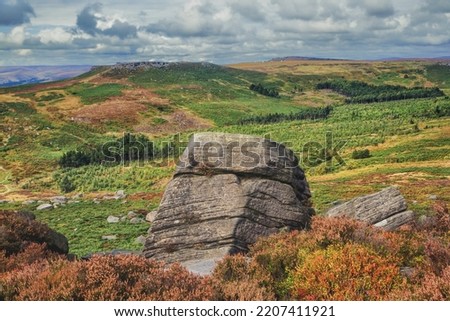 Burbage Edge is a gritstone escarpment overlooking the Burbage district of Buxton in Derbyshire, in the Peak District. The hill's summit is 500 metres above sea level.  Royalty-Free Stock Photo #2207411921