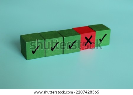 Wooden cubes with right and wrong icon. Violation contract terms, termination, corruption, failure to comply, system vulnerability concept
