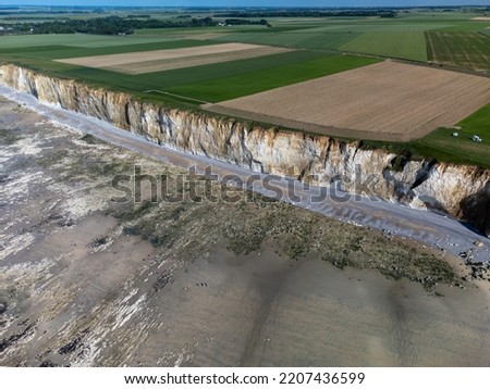 Aerial view on white halk cliffs, green fields of Pays de Caux and water of Atlantic ocean near small village Veules-les-Roses, Normandy, France. Tourists destination. Royalty-Free Stock Photo #2207436599