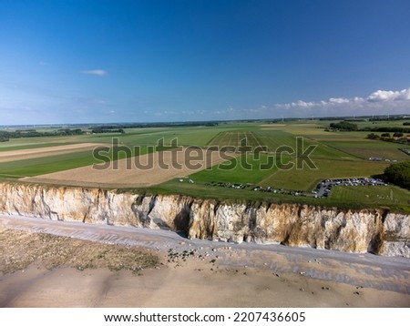 Aerial view on white halk cliffs, green fields of Pays de Caux and water of Atlantic ocean near small village Veules-les-Roses, Normandy, France. Tourists destination. Royalty-Free Stock Photo #2207436605