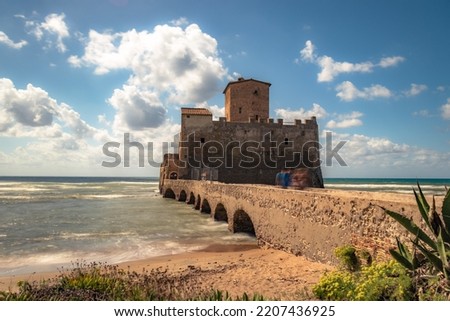 waves splash at the beach in front of the castle Torre Astura, Rome, Italy
 Royalty-Free Stock Photo #2207436925