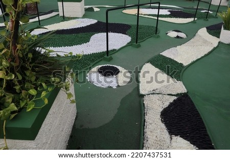 Reflexology area or reflexology area is provided for park visitors. Small stones of various uniform sizes are embedded in the cement by forming a pattern. Massage your feet by stepping on sharp stones Royalty-Free Stock Photo #2207437531