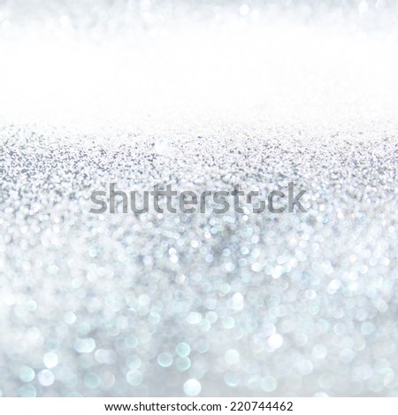Glitter vintage lights background, the silver and black. Image defocused.
