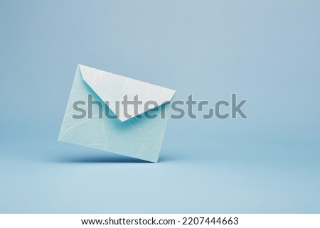 Bright blue color paper office envelope for greeting or invitation with copy space isolated on the bright solid fond plain blue background