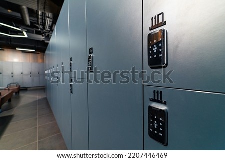 Luxury dark closet lockers. Modern fitness club locker room.