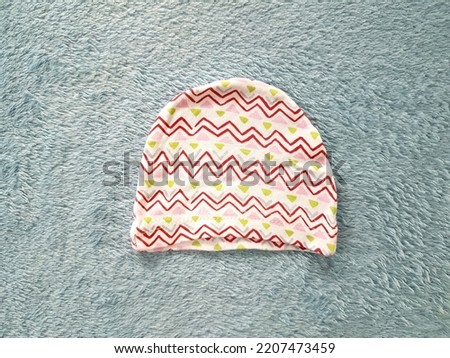 Baby hat with stripes and various colors.