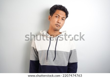 Portrait of fashionable young man wearing hooded jacket