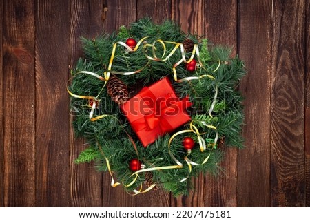 Christmas wreath on wooden background. Mock up. Greeting card.