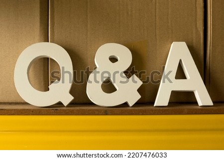 Question and answers concept. Wooden alphabet of letter q and a.