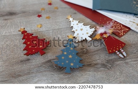 Three wooden Christmas trees and a Christmas angel are handmade wooden decorations for Christmas and New Year.