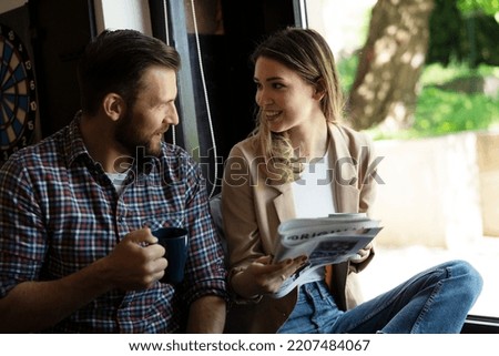 Young happy couple. Boyfriend and girlfriend drinking coffee together.
