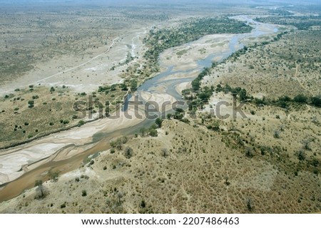 As the dry season sets in the flow of the Great Ruaha river is quickly reduced because of water removed for irrigation upstream for cotton farms. This has been catastrophic for the river ecology Royalty-Free Stock Photo #2207486463