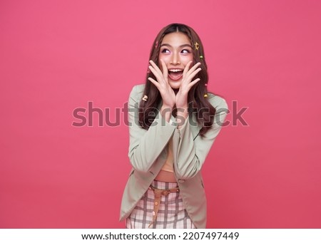 Young Asian teenage girl surprised excited isolated on pink background.