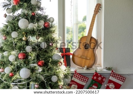Flat lay composition with guitar and Santa hat, space for text. Christmas music