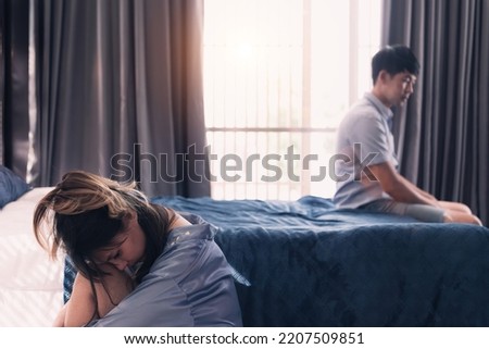asian couple fight over failure relationship. separated couple with dysfunction marriage depressed together in family house. beautiful young wife upset unhappy husband having a divorce in bedroom. Royalty-Free Stock Photo #2207509851