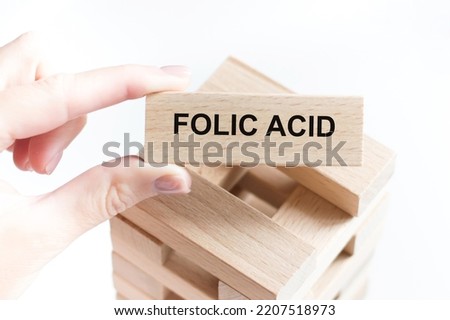 Wooden block form the word FOLIC ACID. Medical concept.