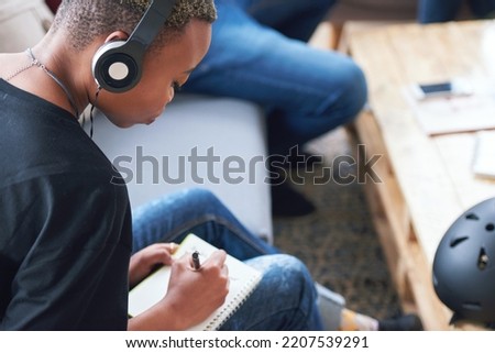 Writing, notebook or black woman or student with planning, learning and listening to music, podcast or radio in class. Studying, research and creative girl with book for university, college or school