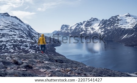Man solo travel hiking in scandinavian mountains active healthy lifestyle adventure travel vacation. Travel concept of discovering, learning and observing nature.