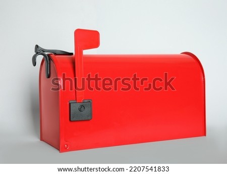 Closed red letter box on light background, closeup