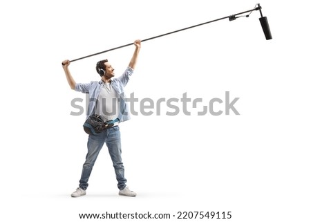Full length shot of sound engineer holding a microphone on stage isolated on white background Royalty-Free Stock Photo #2207549115