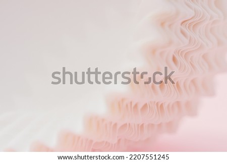 close up macro abstract curves line zig zag of paper cup stack pattern soft light on pastel pink with copy space background.