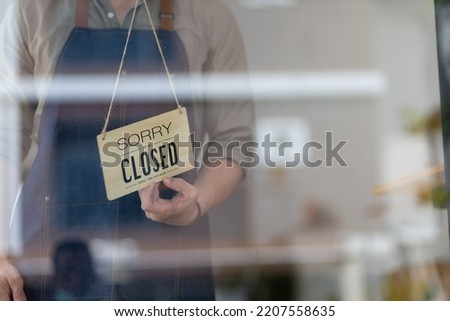 Open sign on the glass door, barista, waitress turning open sign board on glass door in modern cafe coffee shop, cafe restaurant, retail store, small business owner, food and drink.