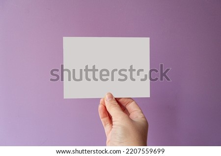 postcard in horizontal format, held by a female hand on a lilac background. For ecommerce or small business