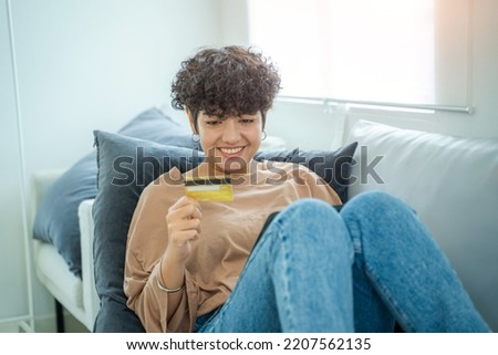 Woman shopping online with notebook using credit card for buy and payment at home,Finance and debit,Lifestyle concept.