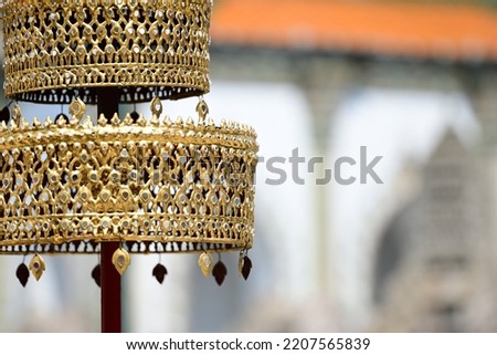 A Part of Golden tiered umbrella With Blurry Background at the Wat Phra Kaew temple in Bangkok, Thailand (Focus in Middle picture and Blurry backgound)