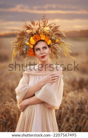 Portrait of a beautiful girl in a wheat field. a charming red-haired Slav with a wheat wreath and flowers on her head. Designer crown. Sunset. art photography