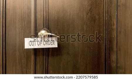 out of order sign hang on the wooden door