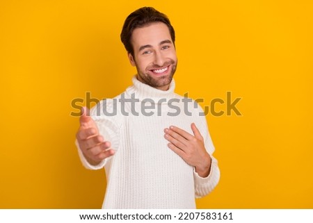 Photo of funny attractive guy wear white pullover giving you arm isolated yellow color background