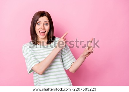 Photo of staring open mouth girl with bob hairstyle dressed striped t-shirt indicating empty space isolated on pink color background