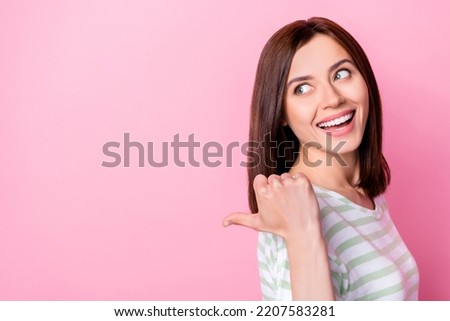 Photo of gorgeous lovely pretty girl with bob hairstyle wear striped t-shirt indicating look empty space isolated on pink color background