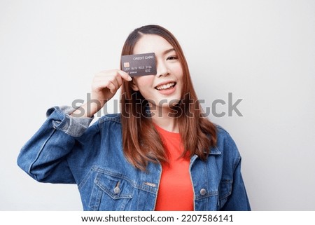 young woman holding credit card smiling happy happy Buying, Payments and Financial Ideas.