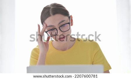 Portrait of Woman having Headache while using Laptop