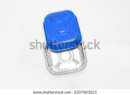 metal food container of blue color on a white background