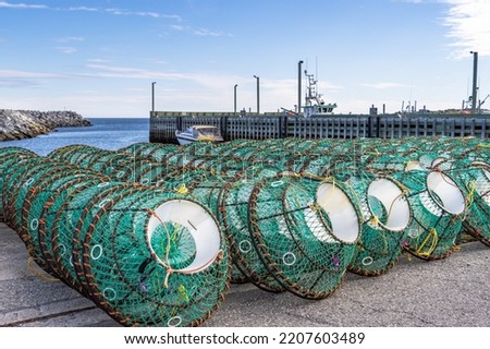 Fishing traps stacked on the pier. Ste-Anne-des-Monts, Gaspesia, Quebec, Canada. Commercial fishing dock.