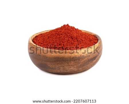 Wooden bowl full of smoked paprika on a white background. Royalty-Free Stock Photo #2207607113