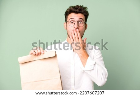 young handsome employee man with a take away food paper bag