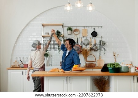 An elderly couple having a meal together. Senior couple having fun cooking together in the kitchen. healthy lifestyle concept happy family Happy time, holiday, cooking Royalty-Free Stock Photo #2207622973