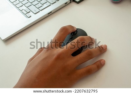 hand handling a mouse on white background Royalty-Free Stock Photo #2207632795