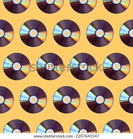 Seamless pattern of CD disks on a yellow background, retro devices.