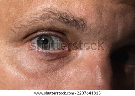Close up studio photo of Caucasian male eye
