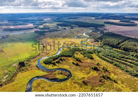 panoramic view from a high altitude of a meandering river in the forest Royalty-Free Stock Photo #2207651657