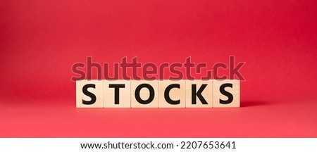 Stocks symbol. Concept word Stocks on wooden cubes. Beautiful red background. Business and Stocks concept. Copy space.