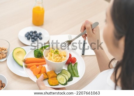 Diet, Dieting asian young woman, girl hand using fork eating egg salad in a bowl with mix vegetables in plate, eat keto food is low fat good health. Nutritionist female, Weight loss for healthy person Royalty-Free Stock Photo #2207661063