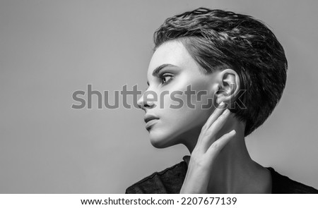 Monochrome portrait of an attractive girl with healthy skin and hair. Care and Beauty Royalty-Free Stock Photo #2207677139