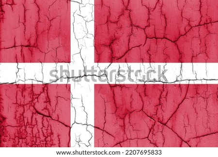 Textured photo of the flag of Denmark with cracks.